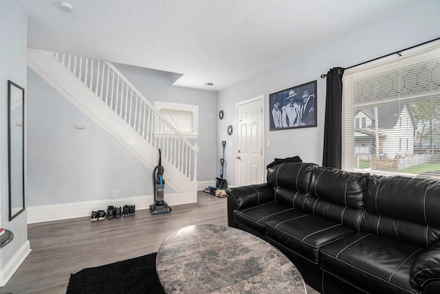 living room with baseboards, stairway, and wood finished floors