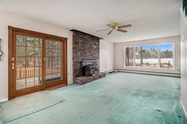 unfurnished living room featuring a baseboard heating unit, a wood stove, a ceiling fan, a textured ceiling, and carpet floors