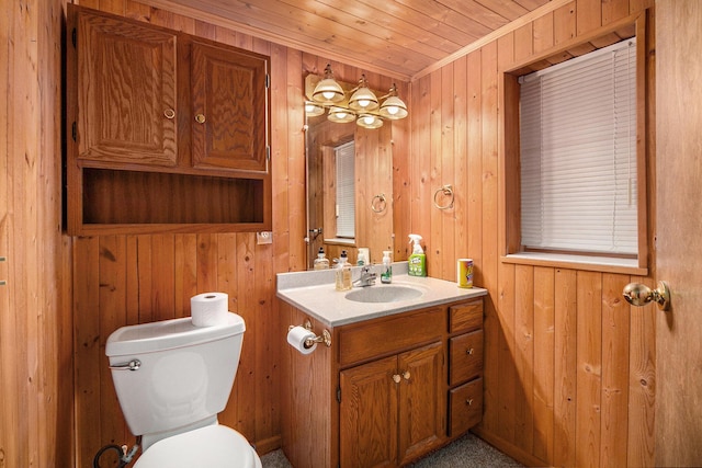 bathroom featuring wooden ceiling, vanity, wooden walls, toilet, and ornamental molding