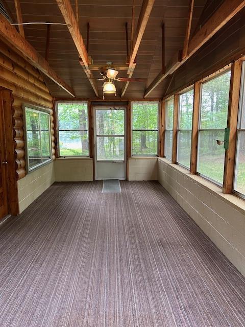 10773 Hamilton Rd, Irons, MI 49644 - unfurnished sunroom with a ceiling fan and carpet floors