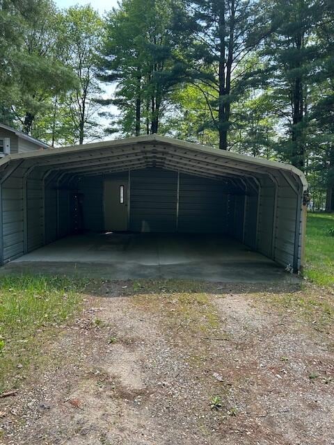 10773 Hamilton Rd, Irons, MI 49644 - view of parking / parking lot featuring driveway and a carport