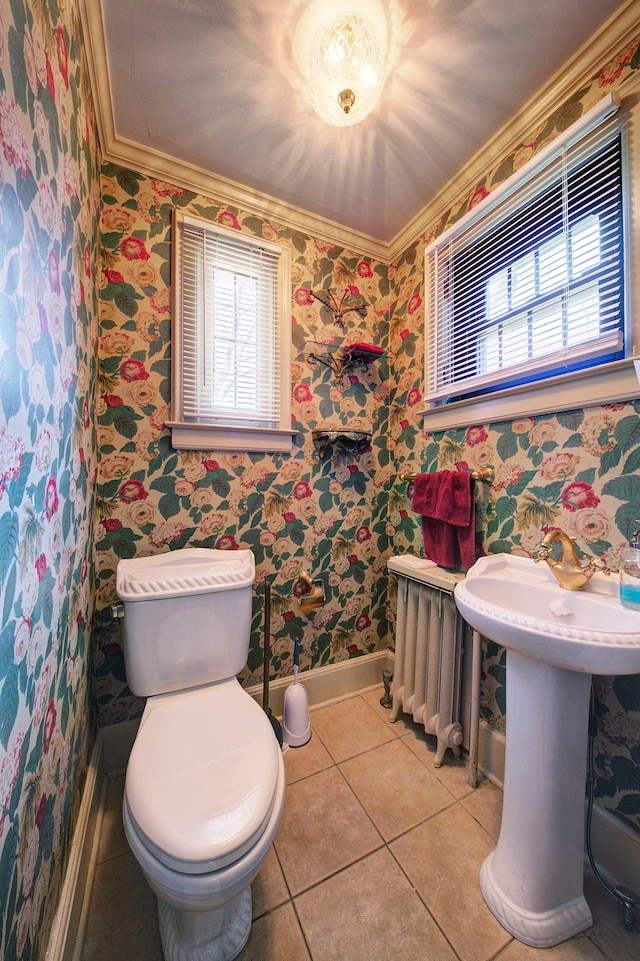 bathroom featuring toilet, tile patterned floors, baseboards, wallpapered walls, and ornamental molding
