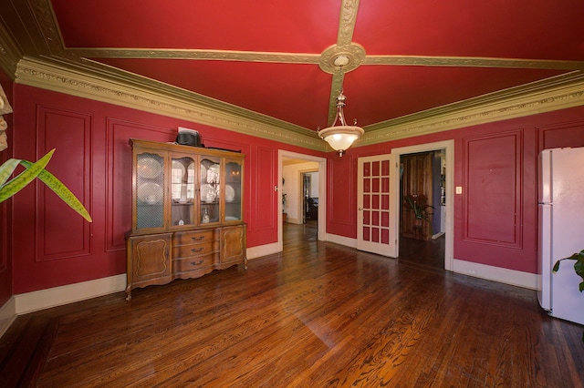 interior space featuring crown molding, baseboards, and wood finished floors
