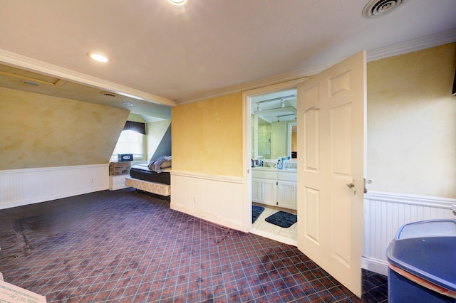 interior space with visible vents, wainscoting, and ornamental molding
