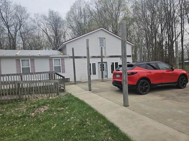 view of front of property with a chimney and a wooden deck