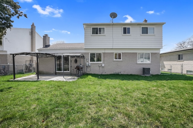 rear view of property with a lawn, a patio area, and a fenced backyard