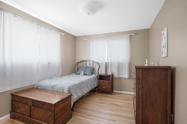 bedroom with baseboards and light wood-style flooring