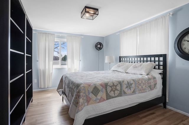 bedroom with wood finished floors and baseboards