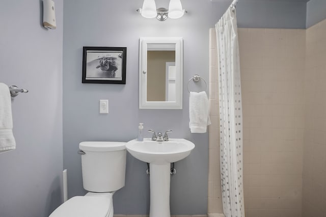 full bath featuring toilet and a tile shower
