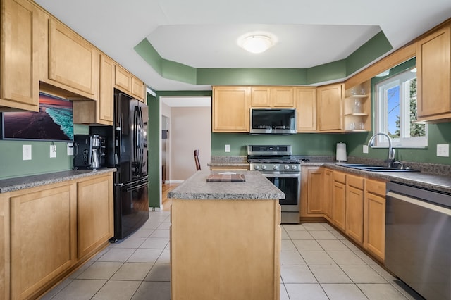 kitchen with a sink, light tile patterned flooring, a center island, light brown cabinetry, and appliances with stainless steel finishes