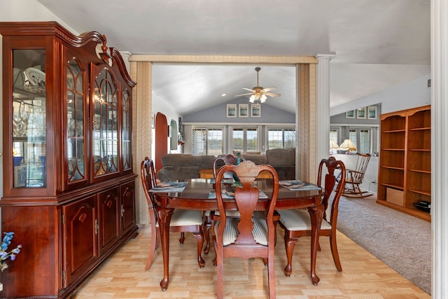 dining space featuring a ceiling fan, light wood-style flooring, and lofted ceiling