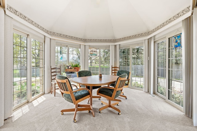 sunroom / solarium featuring visible vents, carpet flooring, and vaulted ceiling