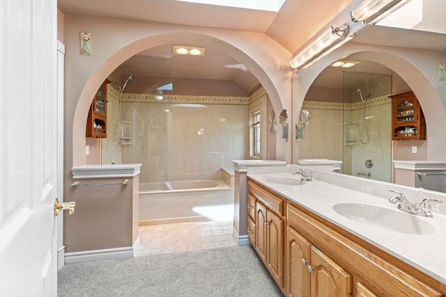 bathroom featuring double vanity, tile patterned floors, tub / shower combination, and a sink