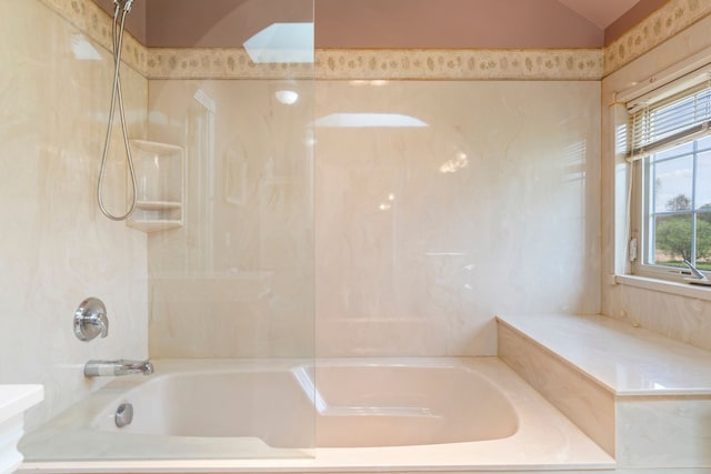 full bathroom featuring washtub / shower combination and lofted ceiling