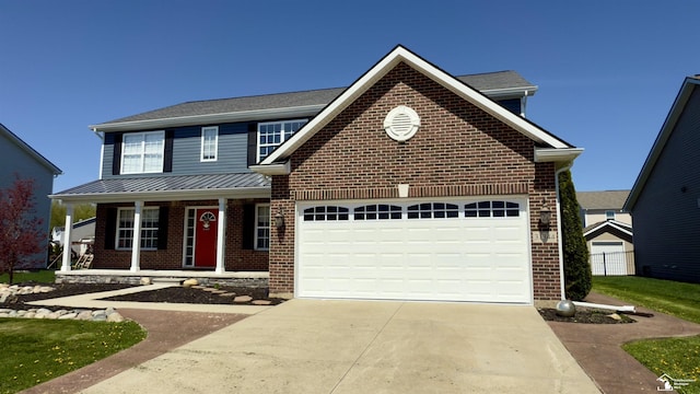 traditional-style home featuring covered porch, brick siding, a garage, and driveway