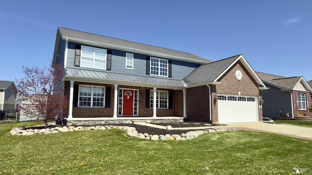 traditional home with a porch, brick siding, a garage, driveway, and a front yard