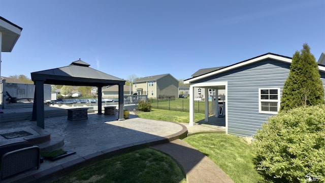 view of yard with fence, a gazebo, and a patio area