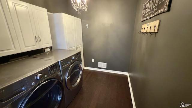 washroom featuring separate washer and dryer, cabinet space, baseboards, visible vents, and dark wood-type flooring