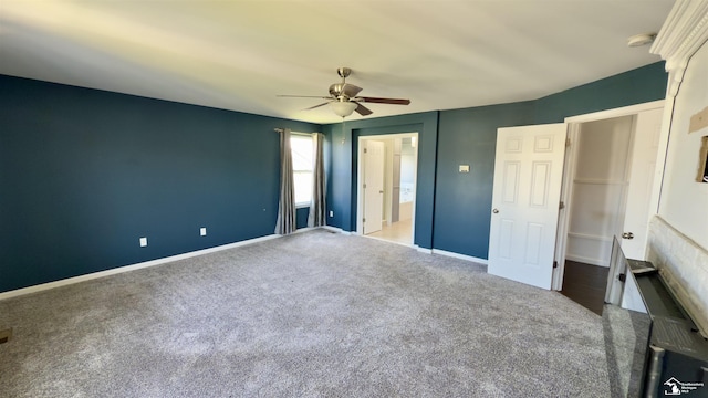 unfurnished bedroom with baseboards, ceiling fan, and carpet flooring
