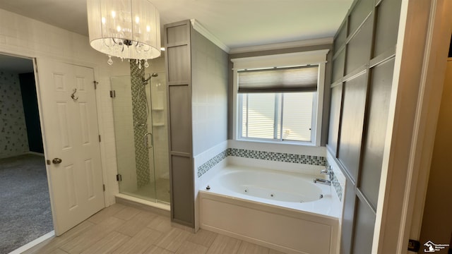 bathroom featuring a shower stall, crown molding, a whirlpool tub, and an inviting chandelier
