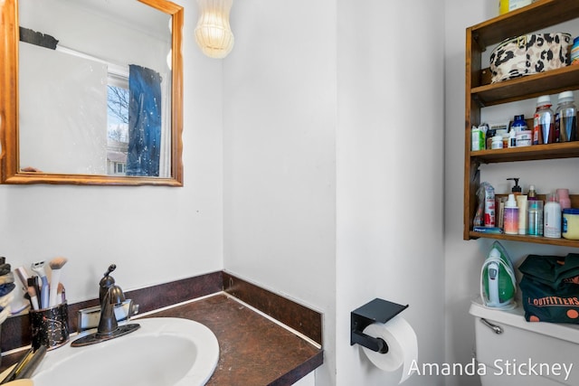 half bath with toilet and a sink
