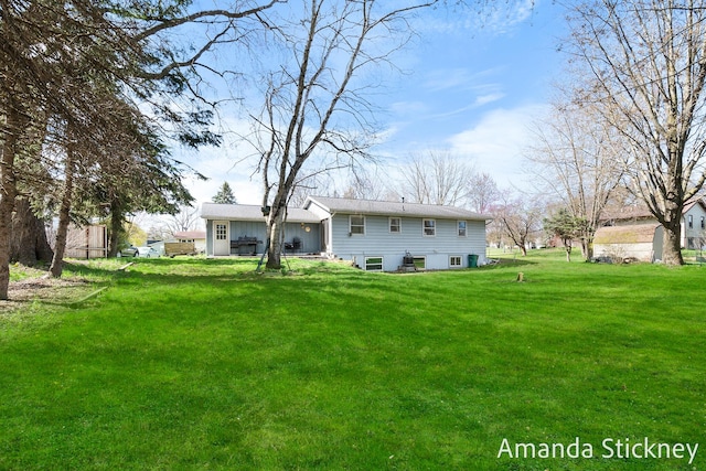 back of property with a yard