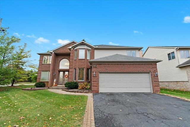traditional-style home featuring brick siding, an attached garage, a front lawn, and aphalt driveway
