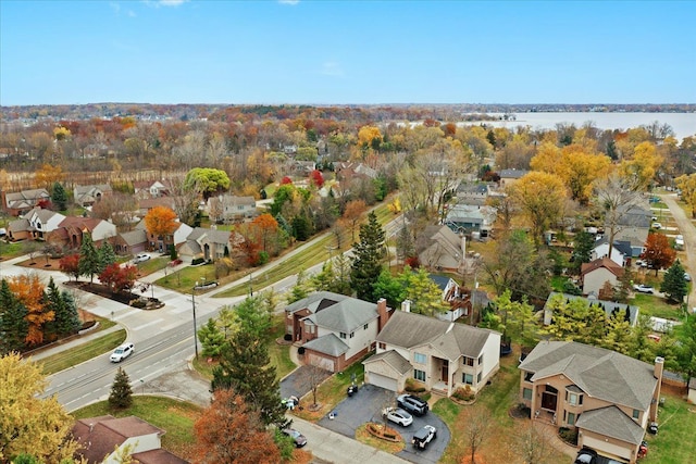 drone / aerial view with a water view and a residential view
