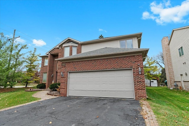 traditional-style house featuring a front yard, driveway, and brick siding