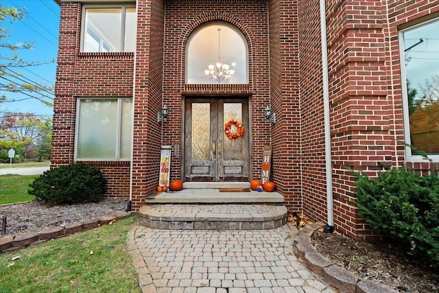 entrance to property featuring french doors and brick siding
