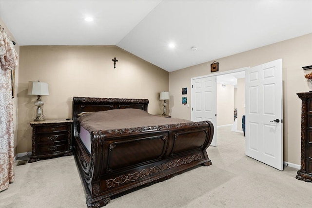 carpeted bedroom with baseboards and vaulted ceiling