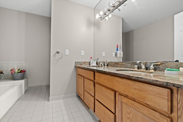 full bath with tile patterned flooring, a sink, a garden tub, and double vanity
