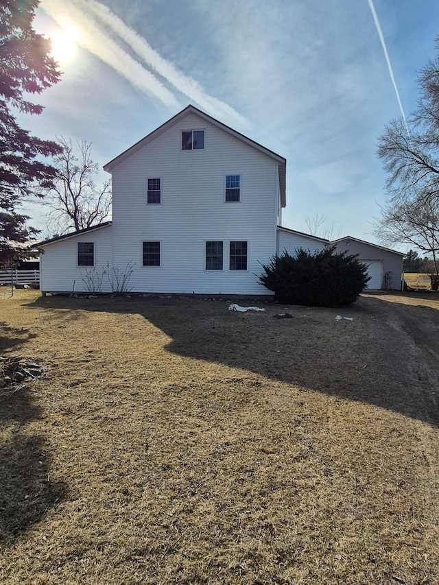 view of home's exterior with a garage and fence