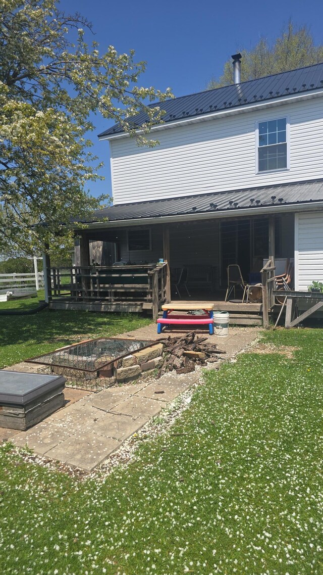 7584 S Brinton Rd, Blanchard, MI 49310 - rear view of property with a yard, metal roof, and a patio area