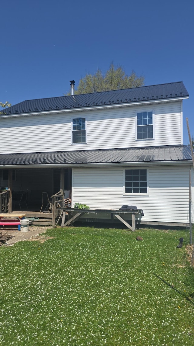 7584 S Brinton Rd, Blanchard, MI 49310 - rear view of property with metal roof and a yard