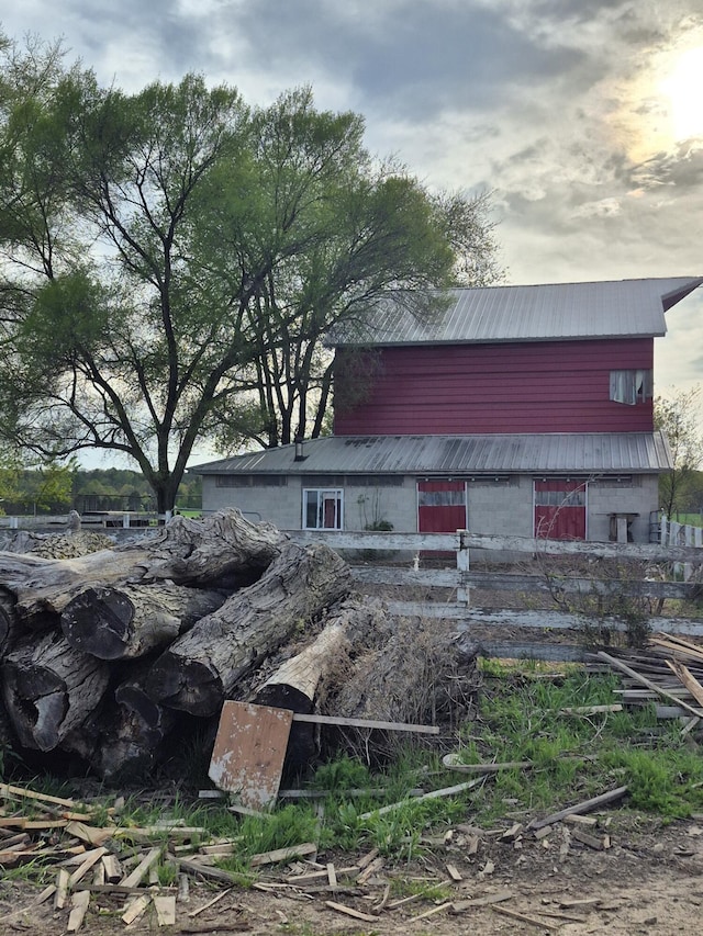 7584 S Brinton Rd, Blanchard, MI 49310 - view of property exterior featuring metal roof, a barn, and an outbuilding