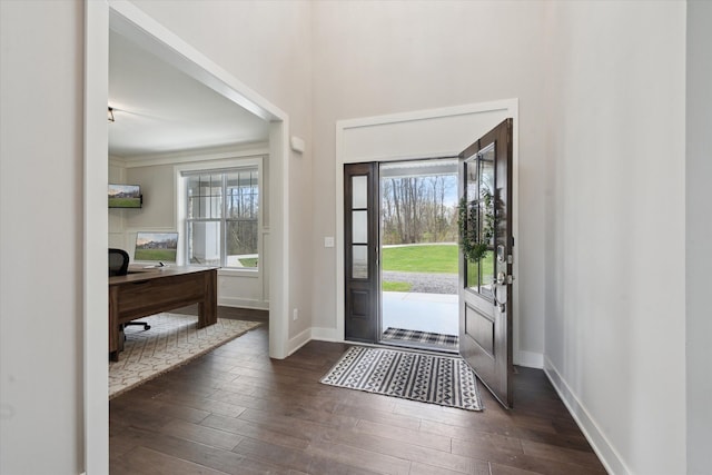 foyer featuring dark wood-style flooring and baseboards