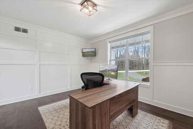 office with visible vents, ornamental molding, a decorative wall, and dark wood-style floors