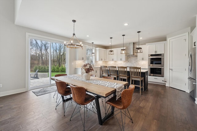 dining area with baseboards, recessed lighting, dark wood finished floors, and a notable chandelier