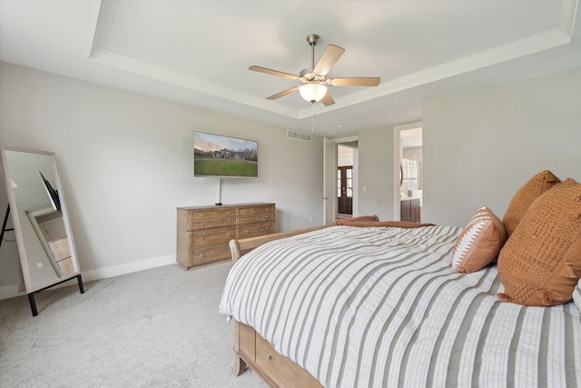 bedroom featuring visible vents, baseboards, ceiling fan, a raised ceiling, and carpet flooring