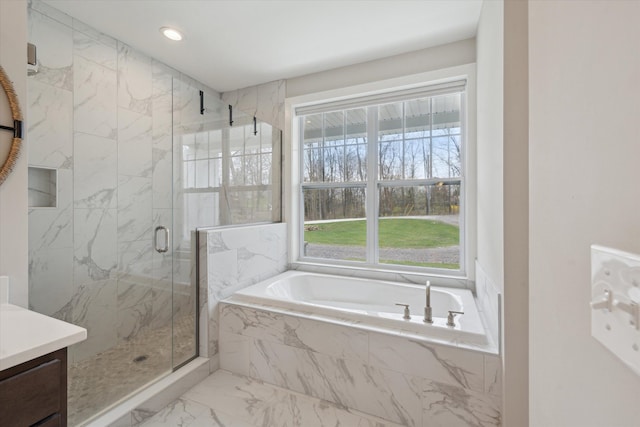 full bathroom with a bath, vanity, marble finish floor, a marble finish shower, and recessed lighting