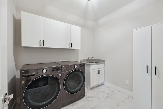 laundry area with washing machine and clothes dryer, cabinet space, a sink, baseboards, and marble finish floor