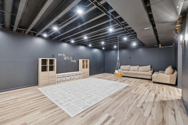 interior space featuring baseboards and wood finished floors