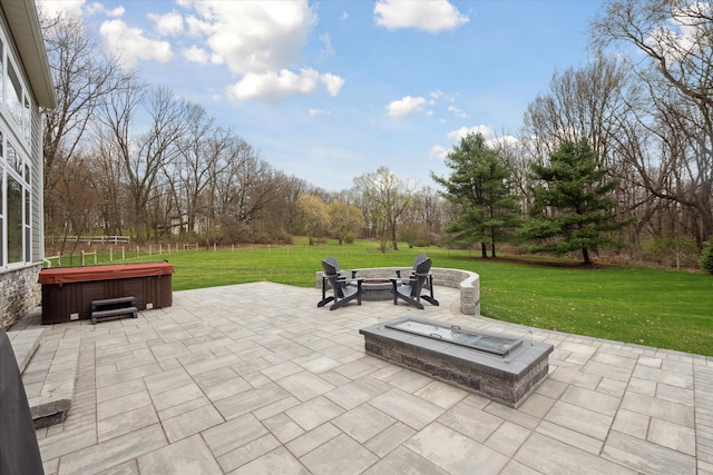 view of patio featuring a hot tub and an outdoor fire pit