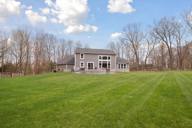 rear view of property featuring a yard