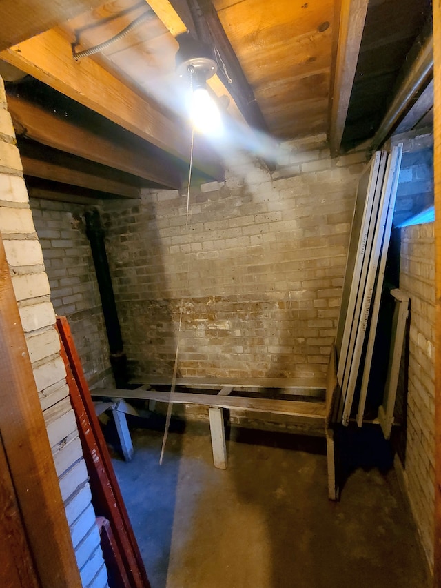 unfinished below grade area with brick wall