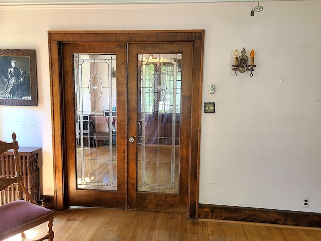 entryway with hardwood / wood-style floors and french doors