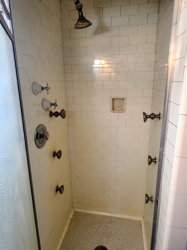 full bathroom featuring tile patterned floors and a stall shower