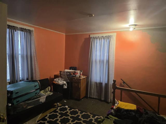 bedroom with carpet floors and crown molding