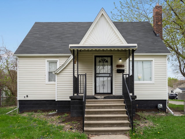 22625 Oaklane St, Warren, MI 48089 - view of front of property with fence, a chimney, and roof with shingles